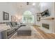 Comfortable living room features vaulted ceilings, hardwood floors, a fireplace, and a large window at 7045 Grand View Way, Suwanee, GA 30024