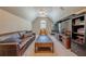 Living area with vaulted ceilings, a leather sofa, TV, and a desk area at 7045 Grand View Way, Suwanee, GA 30024
