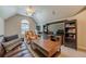 Living area with vaulted ceilings, a leather sofa, TV, and a desk area at 7045 Grand View Way, Suwanee, GA 30024