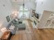 Bright living room with hardwood floors, fireplace, and large windows overlooking the backyard at 7045 Grand View Way, Suwanee, GA 30024