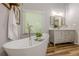 Bright main bathroom featuring a soaking tub, quartz countertop, and modern fixtures at 7045 Grand View Way, Suwanee, GA 30024