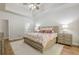Spacious main bedroom suite featuring trey ceilings, french doors to backyard, and hardwood flooring at 7045 Grand View Way, Suwanee, GA 30024