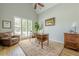 Bright and spacious office featuring a vaulted ceiling, hardwood floors, and large windows with plantation shutters at 7045 Grand View Way, Suwanee, GA 30024