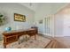 Bright office featuring a dark wood desk, a neutral rug, and white walls with high ceilings at 7045 Grand View Way, Suwanee, GA 30024