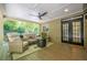 Covered patio with seating area, ceiling fan, and view of the landscaped backyard at 7045 Grand View Way, Suwanee, GA 30024