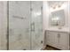 Elegant walk-in shower with marble-look tiles and a glass enclosure in main bathroom at 7045 Grand View Way, Suwanee, GA 30024