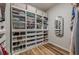 Organized walk-in closet with custom shelving, drawers, and a full-length mirror at 7045 Grand View Way, Suwanee, GA 30024