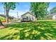 Large grassy backyard of a house featuring mature trees and shade at 1357 Railroad Ave, Sugar Hill, GA 30518
