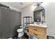 Nicely renovated bathroom with modern vanity, black tile floor, and updated fixtures at 1357 Railroad Ave, Sugar Hill, GA 30518