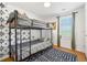 ' bedroom features a sturdy bunk bed, fun wallpaper, and a window at 1357 Railroad Ave, Sugar Hill, GA 30518