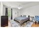 Cozy bedroom features a ceiling fan, area rug, and window for natural light at 1357 Railroad Ave, Sugar Hill, GA 30518