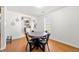 Dining area with wood floors, modern table and seating and natural light at 1357 Railroad Ave, Sugar Hill, GA 30518