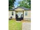 Charming home featuring a welcoming front porch and well-maintained lawn at 1357 Railroad Ave, Sugar Hill, GA 30518