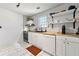 Well-lit kitchen with white cabinets, modern appliances, and stylish backsplash at 1357 Railroad Ave, Sugar Hill, GA 30518