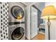 Laundry area features a stacked washer and dryer, plus patterned wallpaper at 1357 Railroad Ave, Sugar Hill, GA 30518