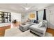 Bright living room with a comfortable sofa, decorative rug, and open floor plan at 1357 Railroad Ave, Sugar Hill, GA 30518