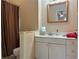 Bathroom with single sink vanity and warm brown stripped shower curtain at 3291 Shady Oak Dr, Atlanta, GA 30340
