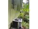 Exterior side view of the home with modern AC unit and banana plants at 3291 Shady Oak Dr, Atlanta, GA 30340