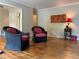 Bright living room featuring hardwood floors, wicker chairs with red cushions, and natural light at 3291 Shady Oak Dr, Atlanta, GA 30340