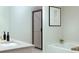 Bright bathroom featuring granite counters, modern fixtures, bathtub and sleek shower with dark trim at 3855 Saddle Bag Ct, Dacula, GA 30019