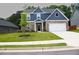 Charming two-story home featuring blue siding, brick accents, a well-manicured lawn, and an attached two-car garage at 3855 Saddle Bag Ct, Dacula, GA 30019