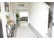 Bright foyer with table and view into living room with a grey sofa, rug, and large window at 3855 Saddle Bag Ct, Dacula, GA 30019
