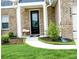 Inviting entryway with manicured landscaping and a charming bench on the walkway leading to the front door at 3855 Saddle Bag Ct, Dacula, GA 30019