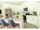 Bright, modern kitchen with white cabinetry, granite counters, and stainless steel appliances at 3855 Saddle Bag Ct, Dacula, GA 30019
