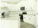 Modern kitchen with white cabinets, granite countertops, and stainless steel appliances at 3855 Saddle Bag Ct, Dacula, GA 30019