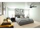 Well-decorated main bedroom featuring a gray upholstered bed and decorative artwork at 3855 Saddle Bag Ct, Dacula, GA 30019