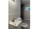 Elegant bathroom featuring a tiled walk-in shower, modern lighting, and a lovely window at 4510 Burks Rd, Forest Park, GA 30297