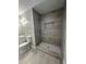 Elegant bathroom with a tiled walk-in shower, modern lighting, and a tiled floor at 4510 Burks Rd, Forest Park, GA 30297
