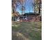 Charming brick home featuring a well-maintained lawn and mature trees providing shade at 4510 Burks Rd, Forest Park, GA 30297