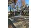 Exterior view of a brick home with a concrete driveway and natural landscaping at 4510 Burks Rd, Forest Park, GA 30297