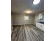 Bright kitchen area with white cabinets, a modern ceiling light, and vinyl flooring at 4510 Burks Rd, Forest Park, GA 30297