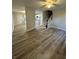 Spacious living room featuring modern flooring, ceiling fan, and staircase access at 4510 Burks Rd, Forest Park, GA 30297