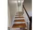 Wooden staircase with white painted risers and a varnished handrail at 4510 Burks Rd, Forest Park, GA 30297