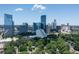 Stunning aerial view showcases the vibrant city skyline nestled among lush green trees and landscaping at 570 Martina Ne Dr, Atlanta, GA 30305