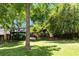 A well-manicured backyard with lush green grass and mature trees providing shade at 570 Martina Ne Dr, Atlanta, GA 30305