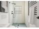 Modern bathroom with a glass-enclosed shower, black matte fixtures, and unique wall tiles at 570 Martina Ne Dr, Atlanta, GA 30305