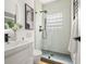 Modern bathroom with a glass-enclosed shower, black matte fixtures, and unique wall tiles at 570 Martina Ne Dr, Atlanta, GA 30305