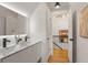 Contemporary bathroom with double sink vanity, modern lighting, and access to the upper level at 570 Martina Ne Dr, Atlanta, GA 30305