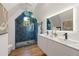Elegant bathroom with blue tiled shower, double vanity, and modern fixtures at 570 Martina Ne Dr, Atlanta, GA 30305