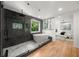 Bathroom featuring soaker tub, glass shower, sleek tile work, and modern fixtures at 570 Martina Ne Dr, Atlanta, GA 30305