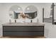 Bathroom featuring a double vanity with modern fixtures and twin round mirrors at 570 Martina Ne Dr, Atlanta, GA 30305