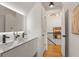 Modern bathroom with double vanity, sleek fixtures, and access to the stairway at 570 Martina Ne Dr, Atlanta, GA 30305