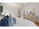 A bright bedroom with natural light, with an elegant dresser, and a door leading to another room at 570 Martina Ne Dr, Atlanta, GA 30305