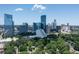 Aerial view showing Buckhead skyline with modern buildings against lush greenery at 570 Martina Ne Dr, Atlanta, GA 30305