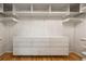 Bright walk-in closet with custom storage, lots of shelving, and hardwood floors at 570 Martina Ne Dr, Atlanta, GA 30305