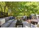 Wooden deck featuring comfortable lounge seating and outdoor decor with a view of the tree-filled backyard at 570 Martina Ne Dr, Atlanta, GA 30305